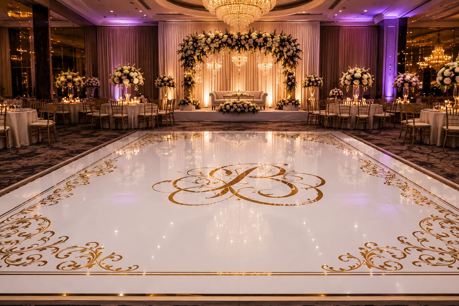 Custom white and gold monogram vinyl dance floor wrap installed in an elegant Houston wedding banquet hall